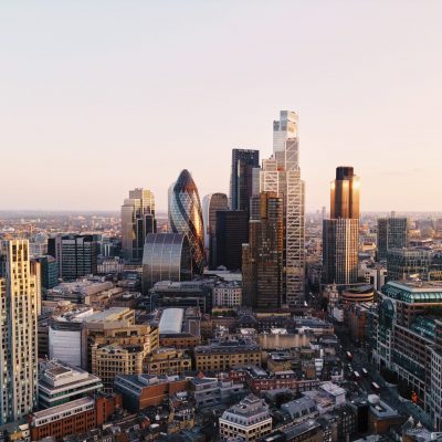 UK, London, elevated view over city financial district skyline at sunset